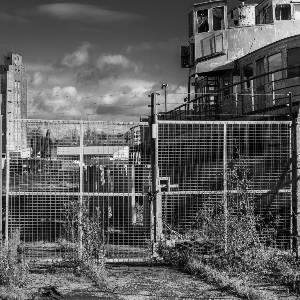 a lgate with barbed wire prevents access to the dockside at Sharpness